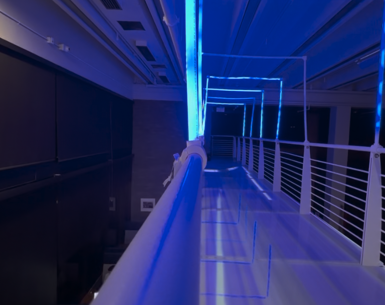 Custom 3D-printed felt-lined brackets clamped to the bridge railing